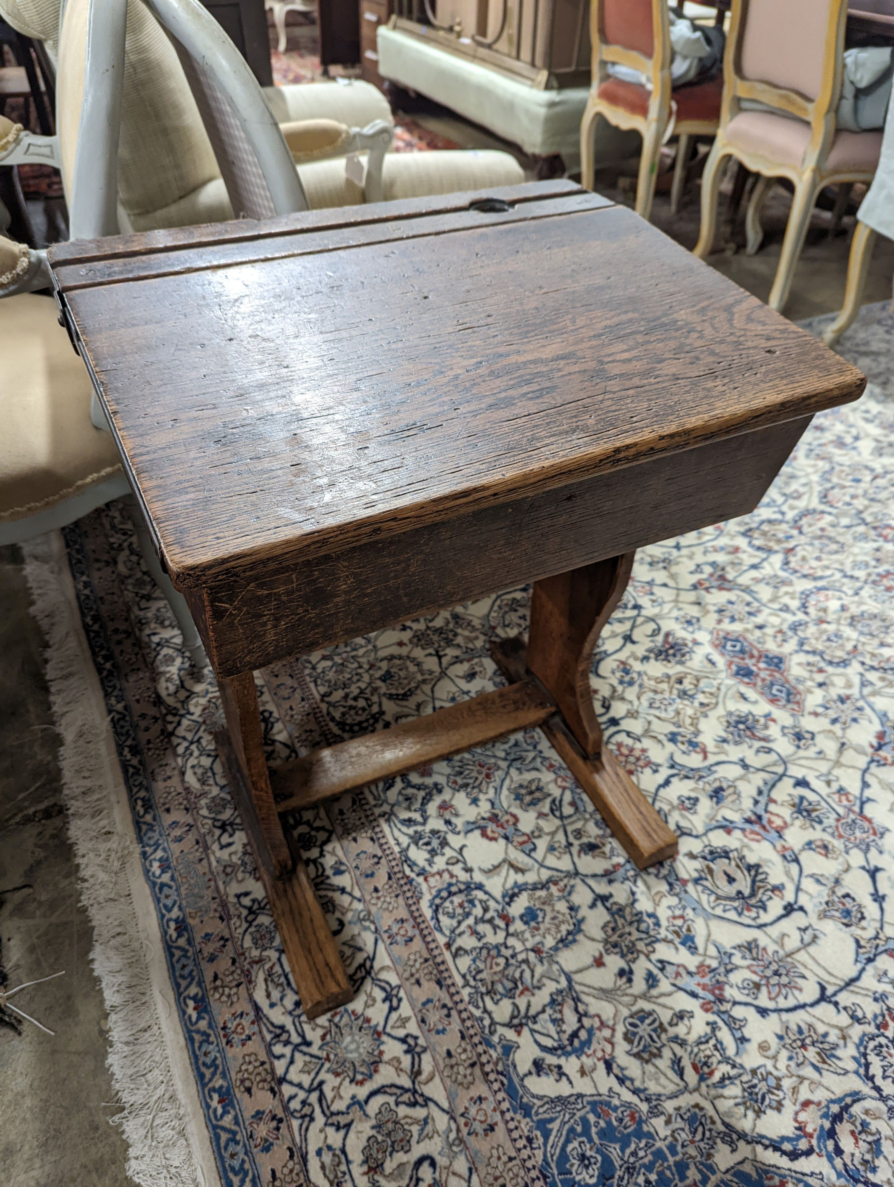 A vintage oak student's desk, width 57cm, depth 46cm, height 71cm with a beech and elm chair